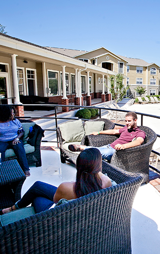 Georgia Southern students enjoying conversation by the pool at Freedom's Landing, one of the many incredible residence halls located on campus. 